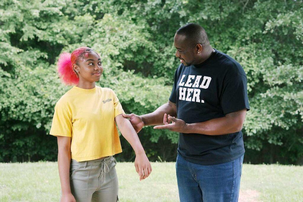 Brown dad teaching his daughter